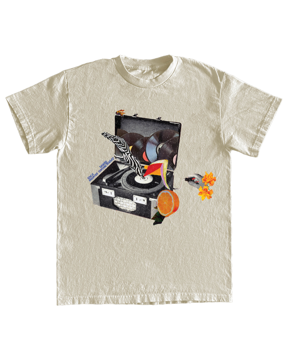 Cream-colored t-shirt laying flat on a white background. There is a fanciful collage on the t-shirt that features an open black and white record player that has one record playing and others stored in the lid. Colorful leg-like appendages are coming out of one of the records and an orange fruit is collaged on the bottom right corner of the record player. A disembodied hand is holding a lever attached to the record player that presumably turns the player on.