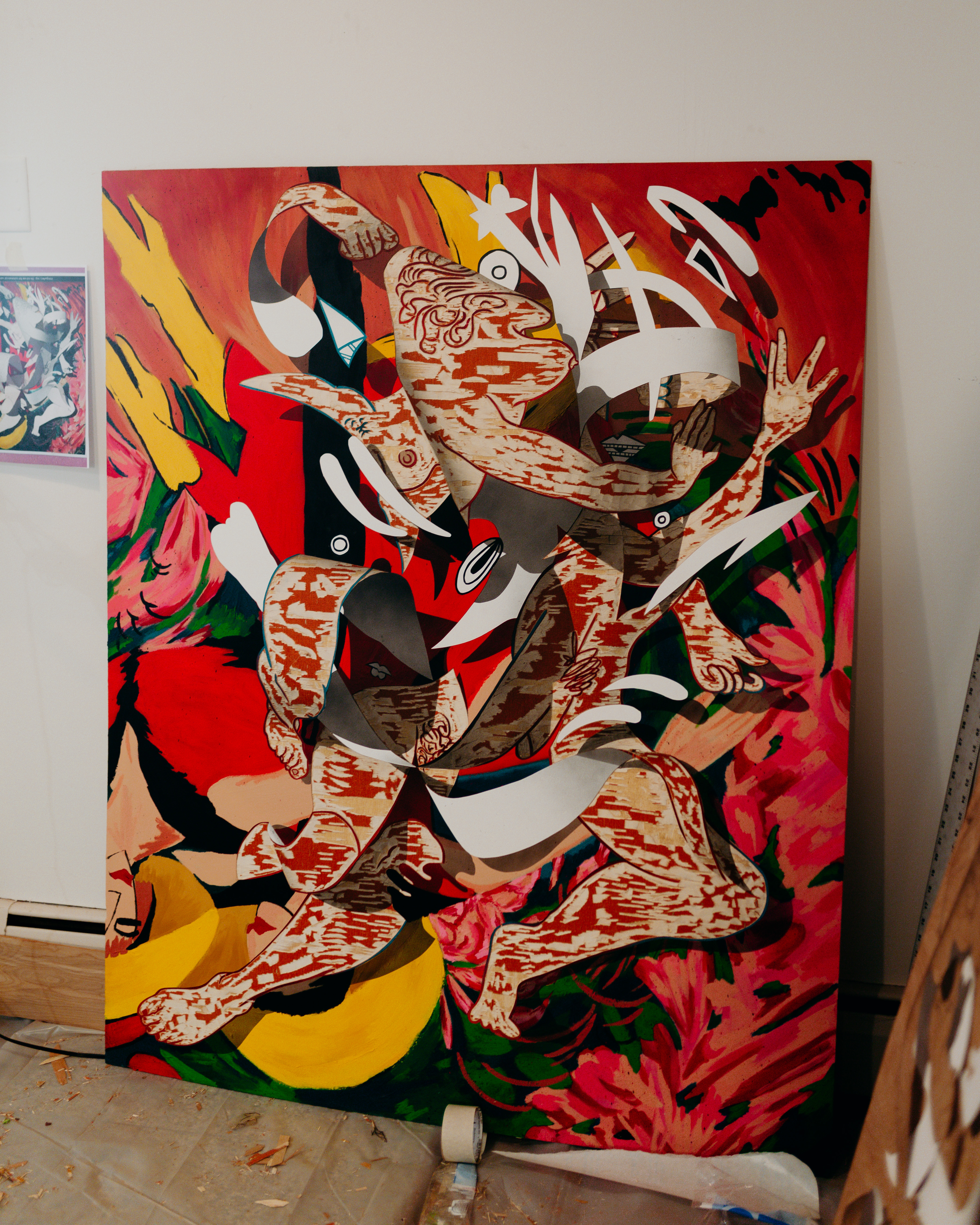 A large painting creates the illusian of paper swirling above the surface of the canvas. 
