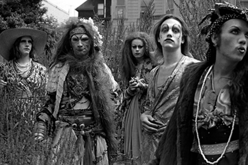 Black and white image of five people in theatrical makeup at an outdoor space.