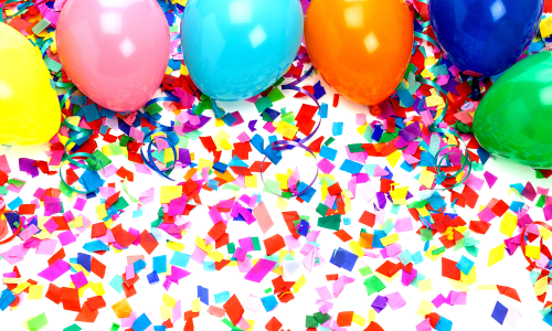 colorful balloons and confetti laying on a white background