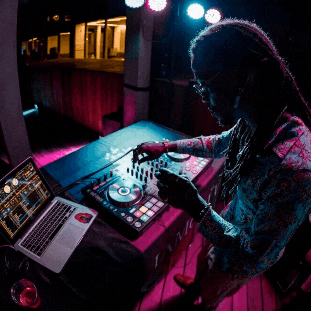 Gif of a DJ playing at a party at night.