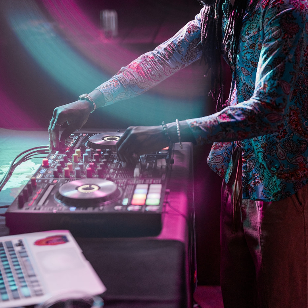 Close up of a DJ on a mixing board.