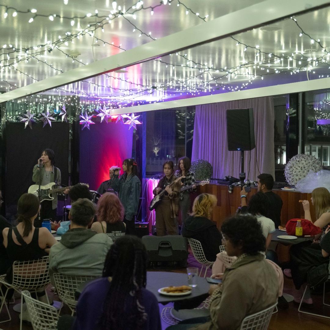 Party in a cafe with glittery streamers hanging down from the ceiling.