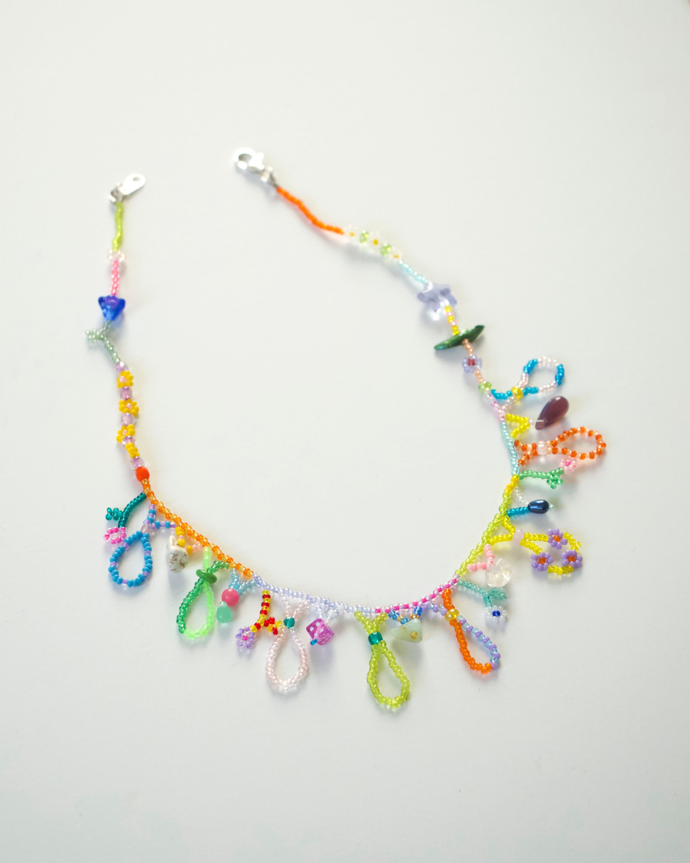 Beaded colorful, whimsical necklace on a white background.