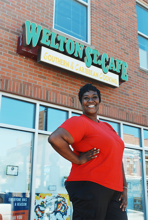Portrait photo of Fathima Dickerson in front of Welton Street Cafe in Five Points, Denver, CO