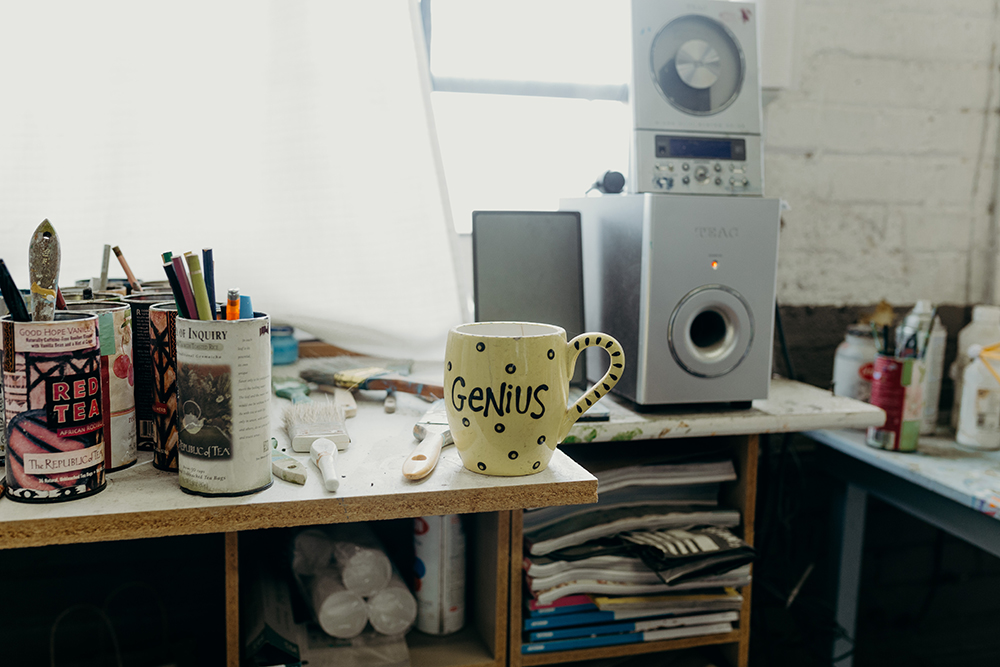Photo of Genius mug on Clark's desk in his artist studio