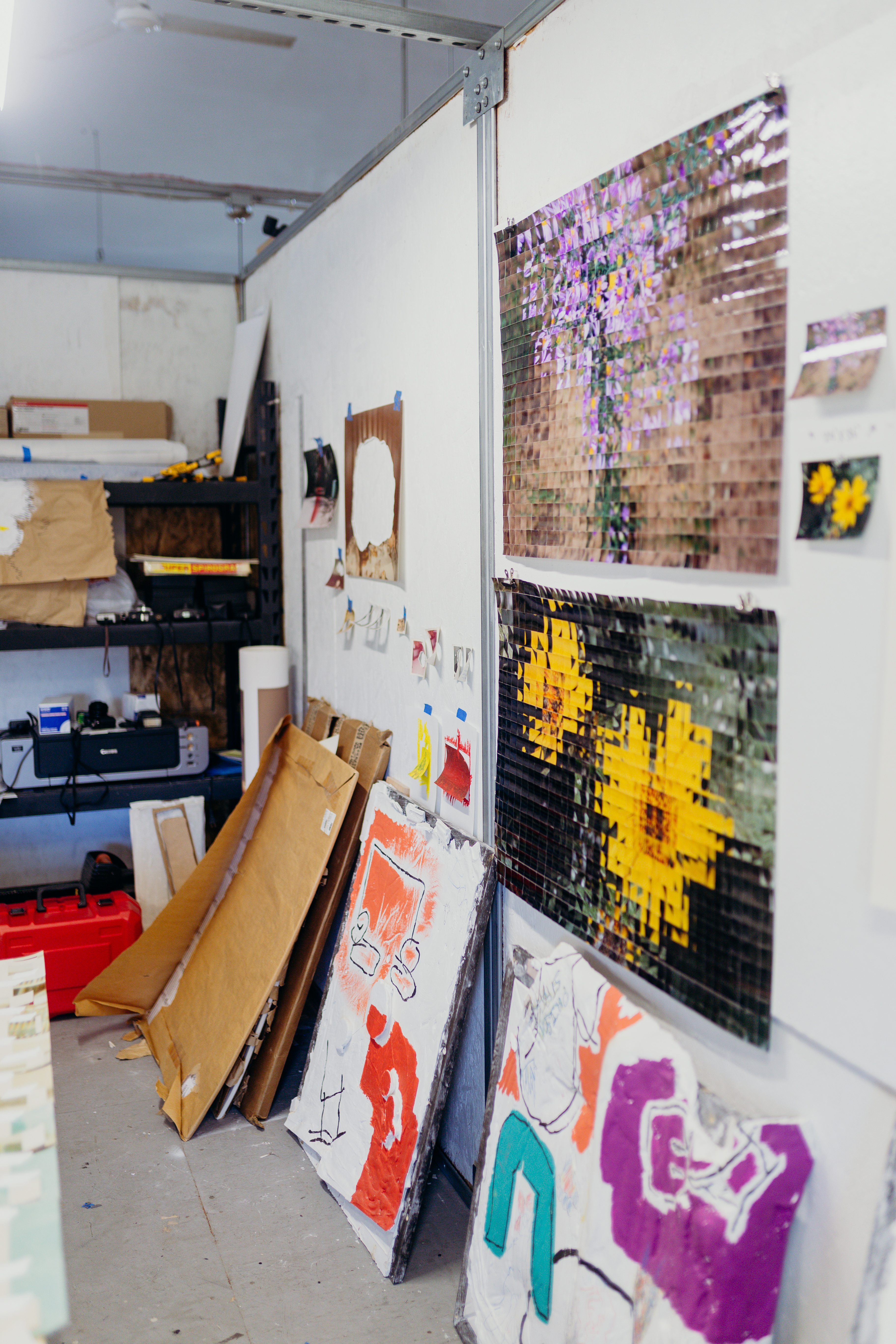 Several artworks stacked against a wall in George P. Perez's studio