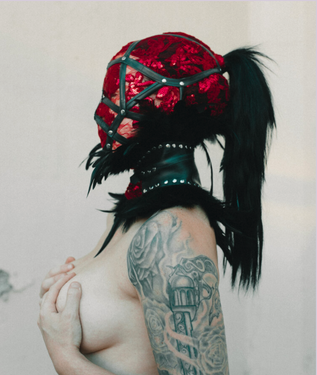 Profile shot of a woman in a head harness with red lace