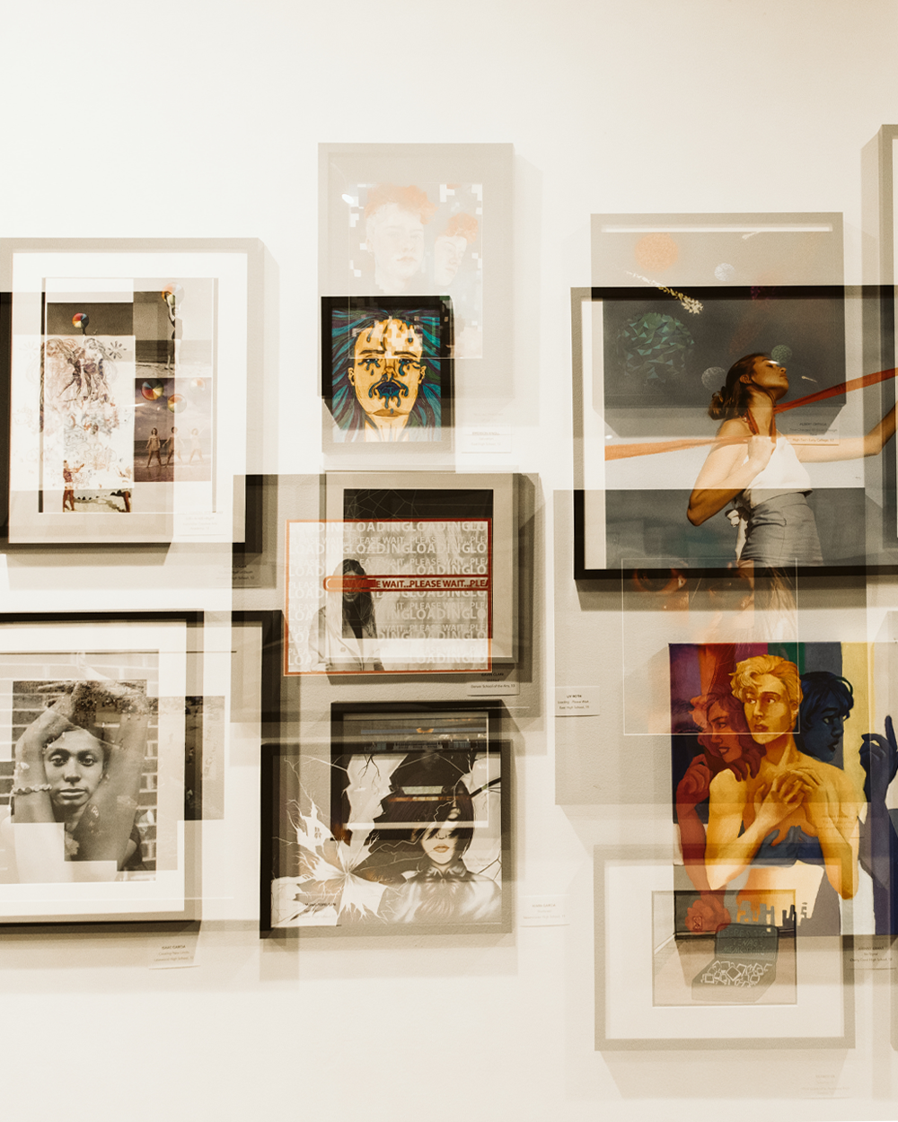 photograph of a teen exhibition with a variety of images on the gallery wall.