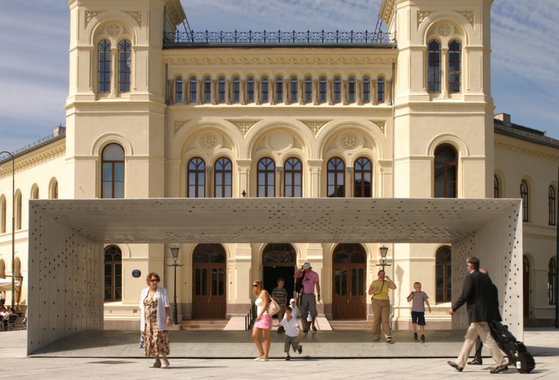 Nobel Peace Center in Oslo. People gather in front of the cream colored building.