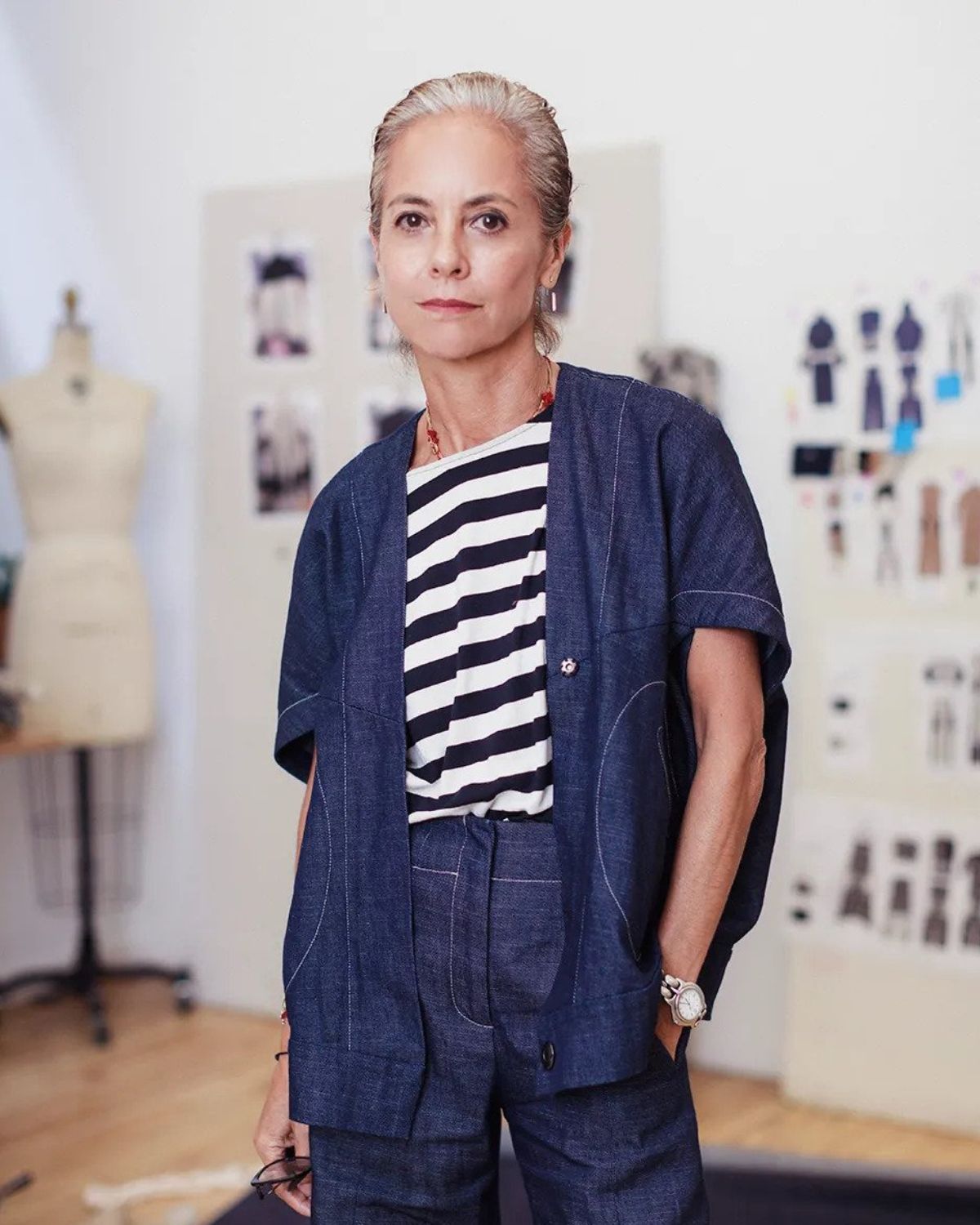 Designer Maria Cornejo wearing a matching navy blue pants and jacket with a striped t-shirt underneath.