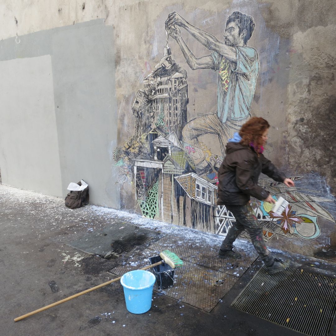 Street artist Caledonia Curry, known as Swoon, working on an artwork in the streets.