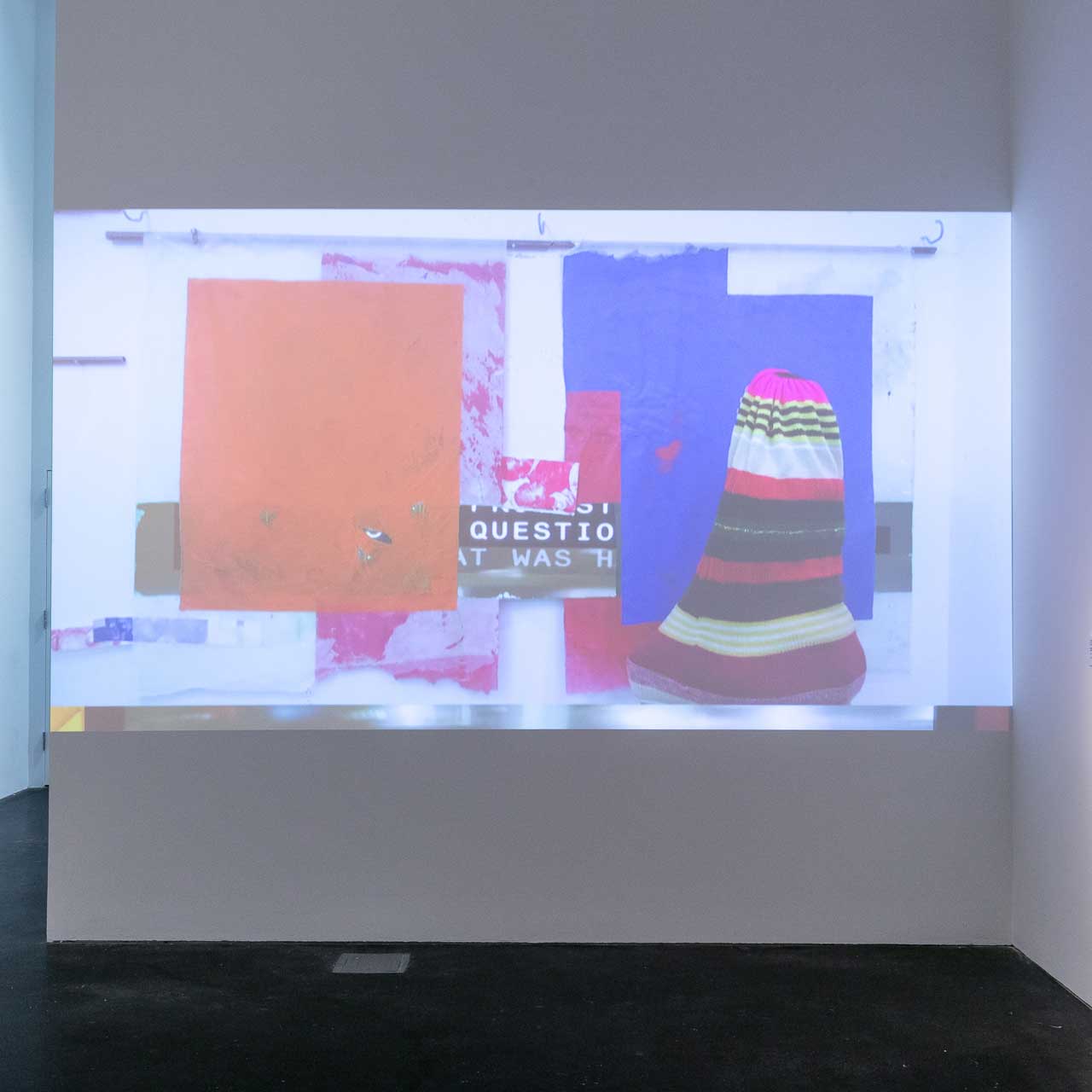 A colorful video projected onto a wall.