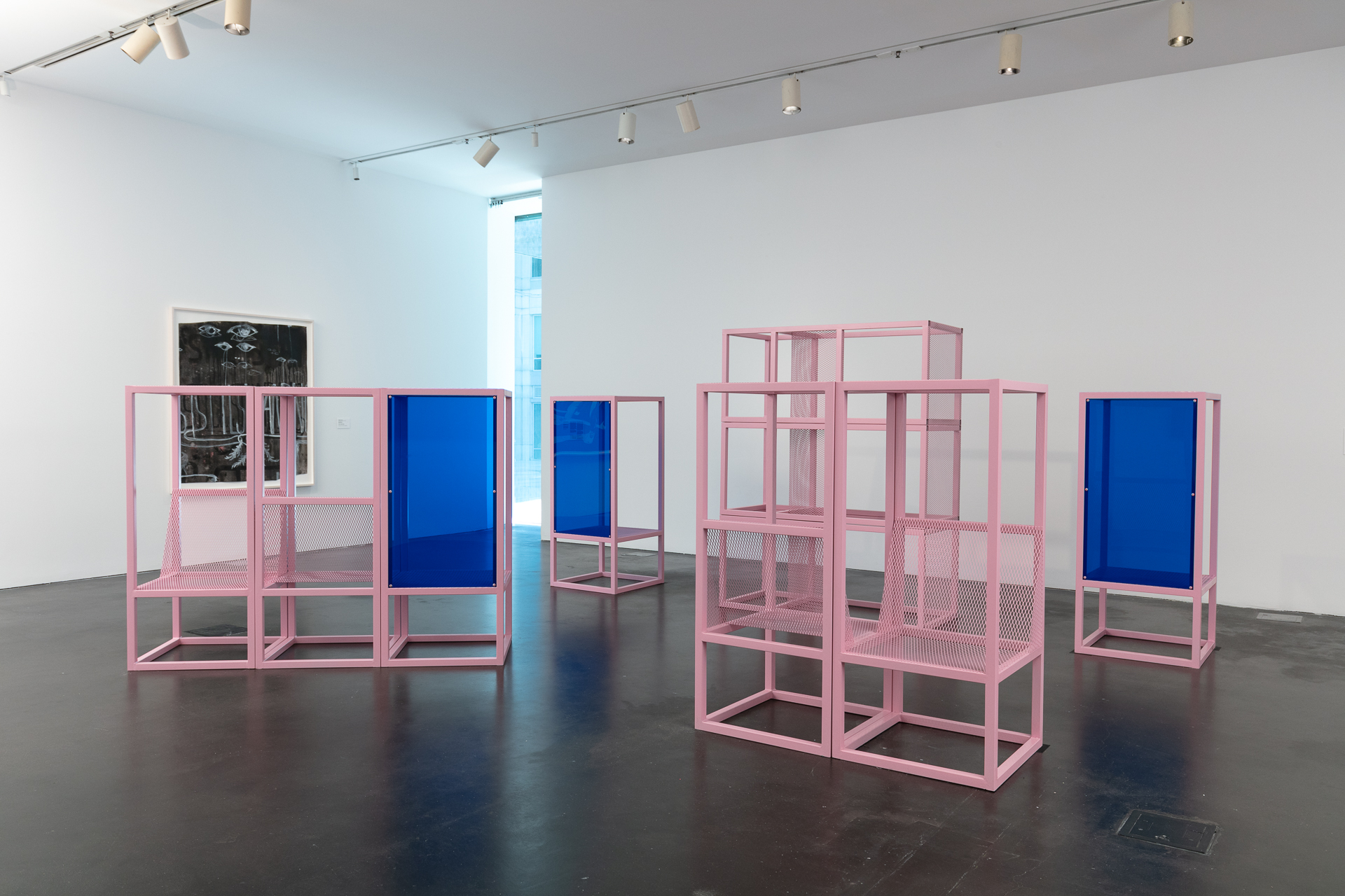 Pink and blue modular metal structure in a gallery.