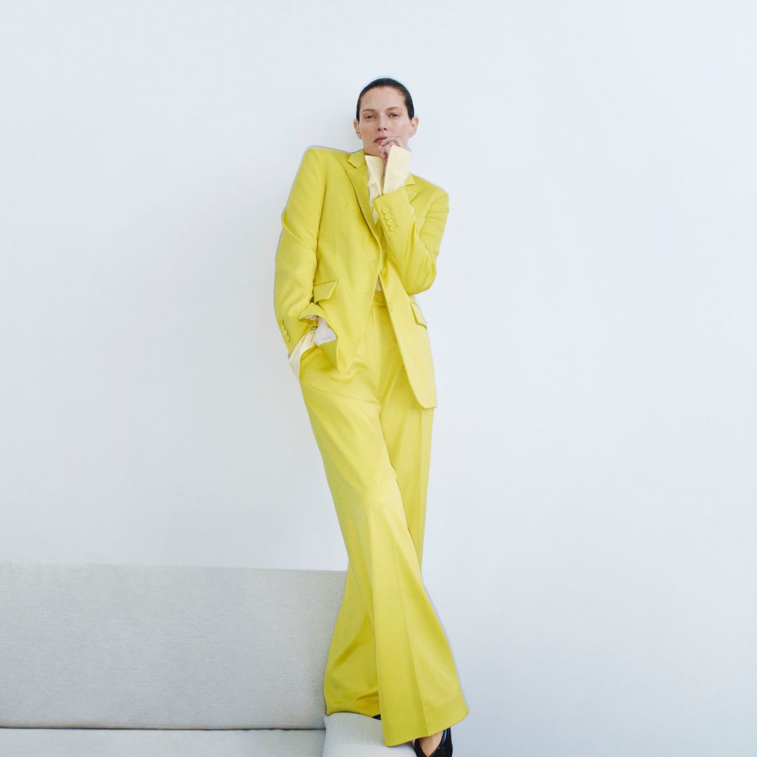 Model sporting a yellow pant suit. 
