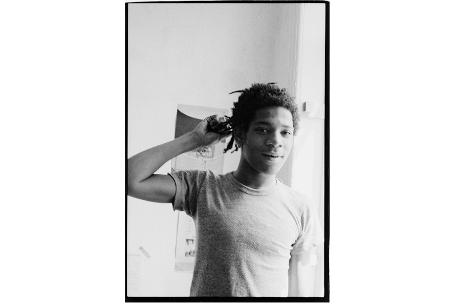 Basquiat in the apartment, 1981. Archival pigment print, 10 1/2 x 8 inches. Photograph by Alexis Adler.
