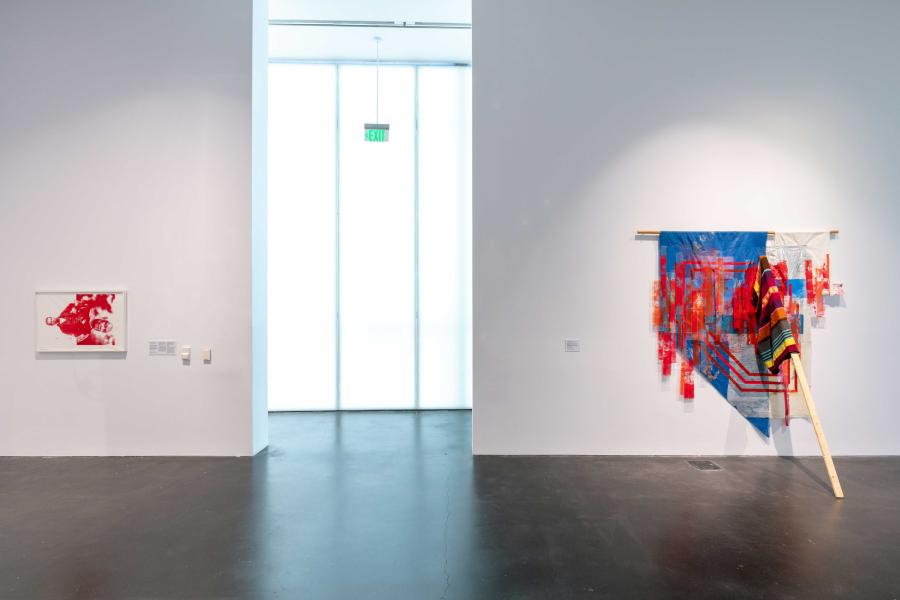 Two colorful works of art hung on white walls in an MCA Denver gallery.