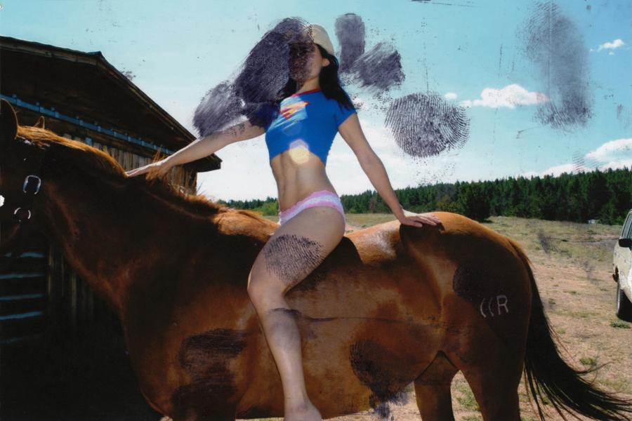 Photograph of the artist riding a horse in underwear and a cropped t-shirt.