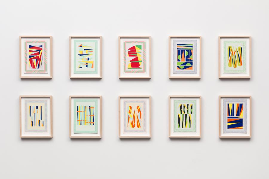 10 colorful abstract artworks framed and hung on a wall.