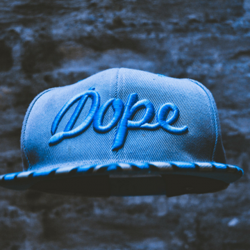 Blue flatbill hat with text reading "Dope" in blue cursive.