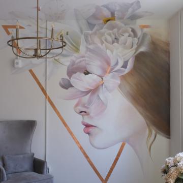 Mural of the profile of a person with flowers obstructing their face.