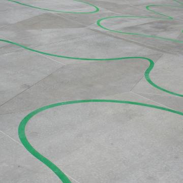 Curved green line on pavement.