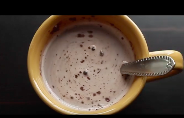 Close up image of hot chocolate in a yellow mug