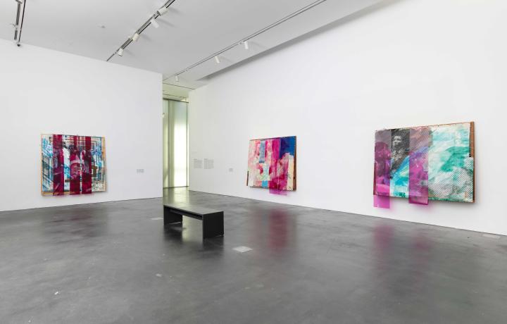 Three large, colorful, abstract artworks hung on white walls in an MCA Denver gallery.