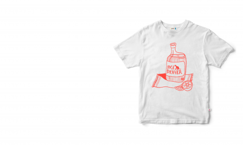 White t-shirt on a white background with a red design on it. The design features a bottle of tequila with the words “MCA DENVER” on the label. The bottle is full, and is sitting on a small rug, with fruit (perhaps oranges) next to it.