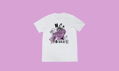 T-shirt on purple background. The t-shirt reads, “MCA Denver” and there is a head of a figure on it. The figure is sporting grills, there are flowers surrounding the figure, and there is a swirly vortex replacing where the figure’s eyes might have been.