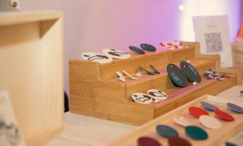 Colorful clay earrings displayed on a table.