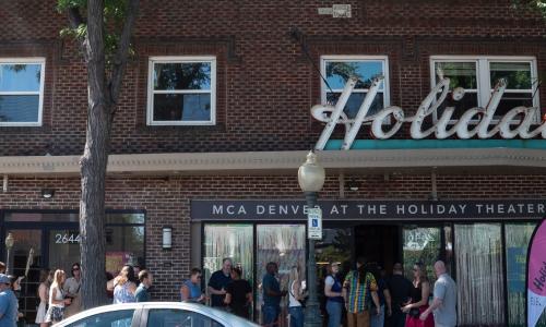 Brick building with the word "Holiday" on the marquee. 