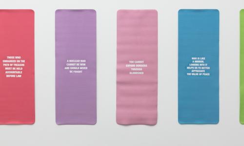 Colorful yoga mats hung on a wall.